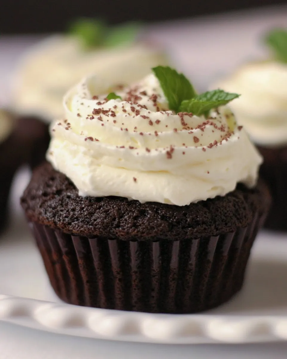 Delicious Fudgy Brownie Cupcakes with fresh whipped cream mint topping image